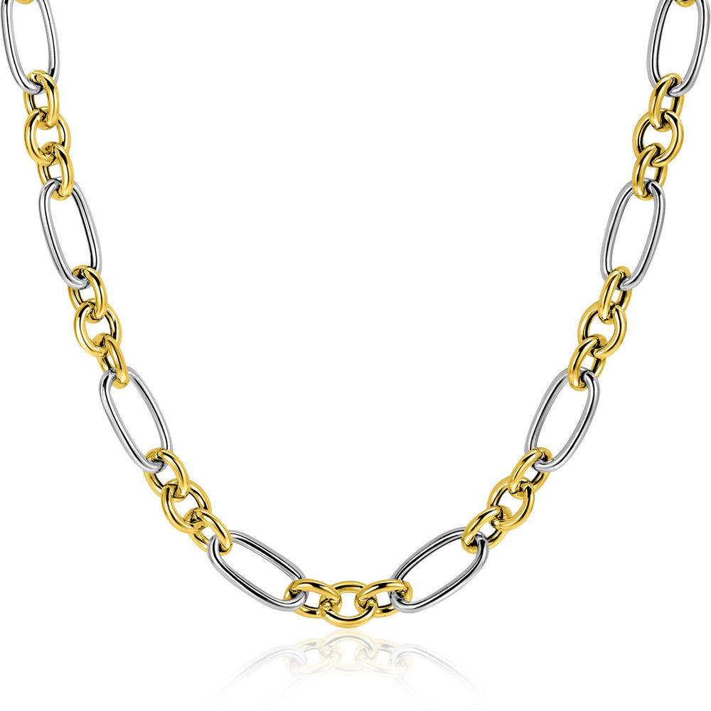 De Zinzi ketting ZIC2667 45cm toont afwisselend grote gouden en zilveren ovale schakels van het merk Zinzi, elegant weergegeven op een witte achtergrond.