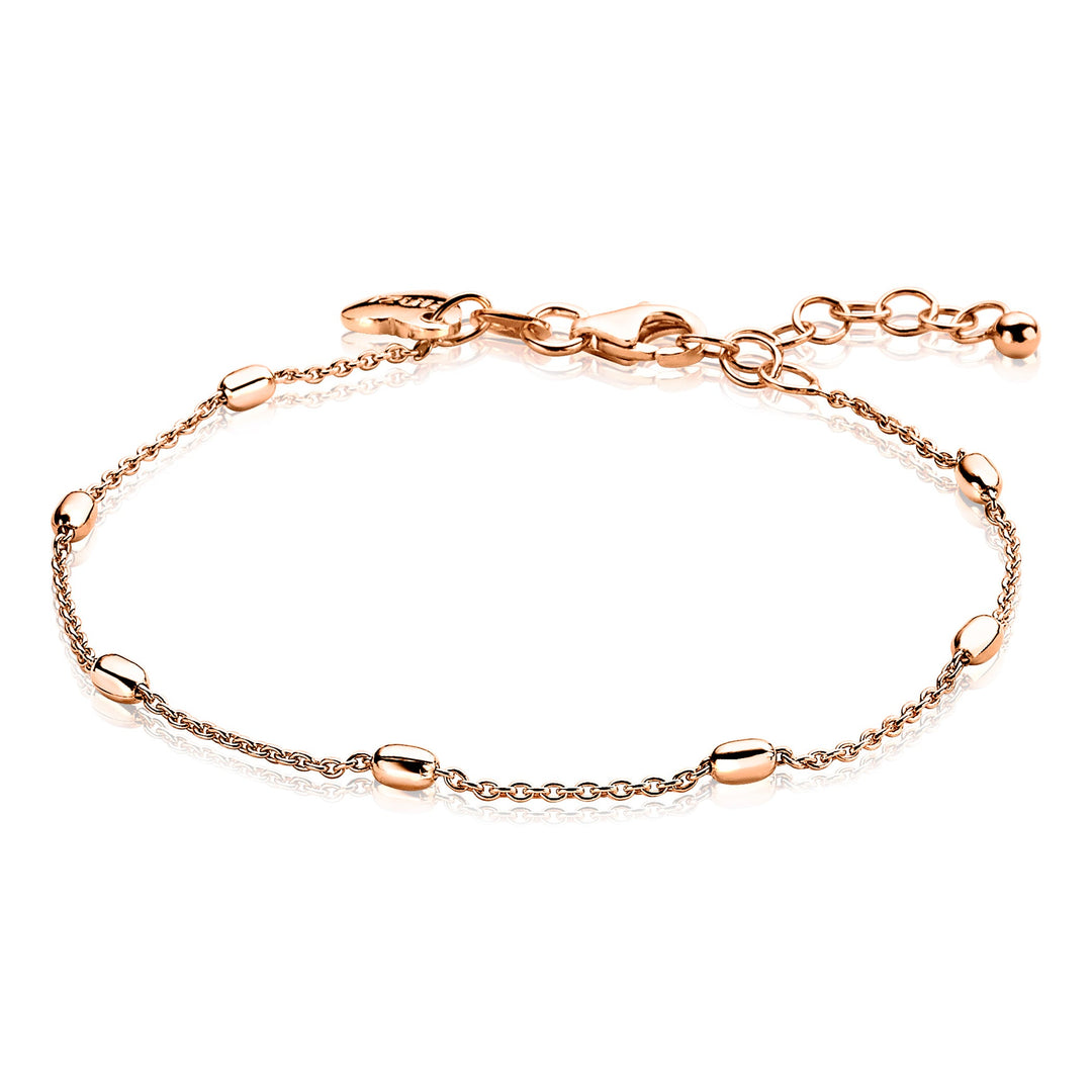 De Zinzi Armband Gold Plated Zia1655 R is een delicate rosé vergulde enkelband in roségoud, versierd met kleine, gelijkmatig verdeelde ovale kralen aan een fijne ketting. Het heeft een veilige karabijnsluiting en een verstelbare ketting die eindigt met een klein bolletje.