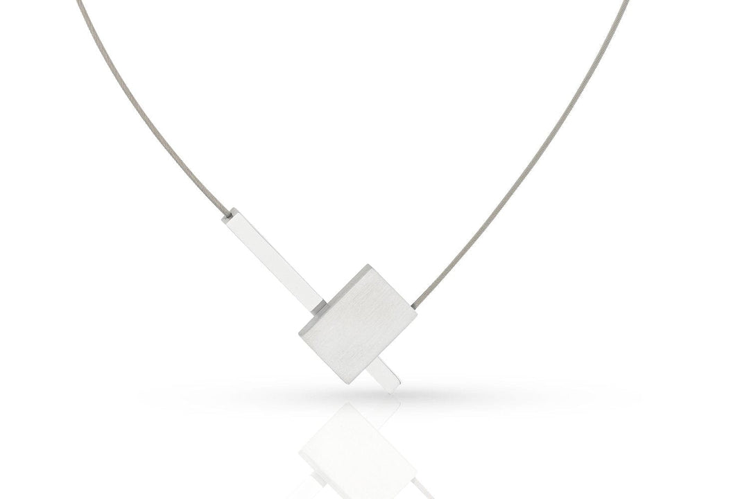 De Collier V-vorm met staafje C261 van CLIC Creations is een minimalistische zilveren ketting met een geometrische hanger, bestaande uit een overlappende rechthoekige vorm en een dun staafje, bevestigd aan een fijne ketting met een magneetsluiting, tegen een witte achtergrond.
