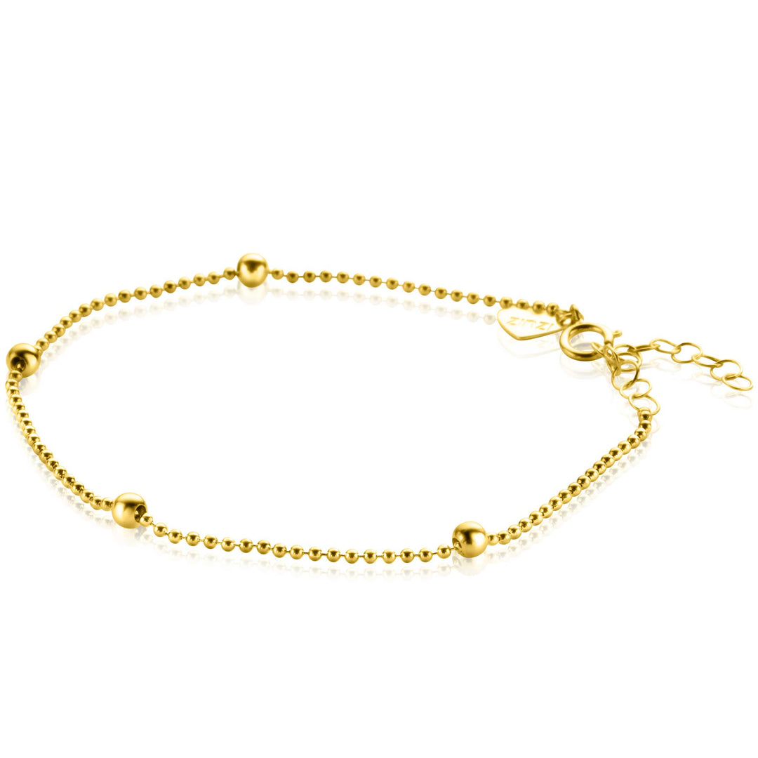 De Zinzi Armband Goud Zga311 is een delicate 14 krt gouden armband met kleine, bolvormige kralen op een dunne ketting. Het bevat een verstelbare sluiting met een verlengketting voor eenvoudig aanpassen van de maat, wat een eenvoudig maar elegant ontwerp biedt dat geschikt is voor elke gelegenheid.