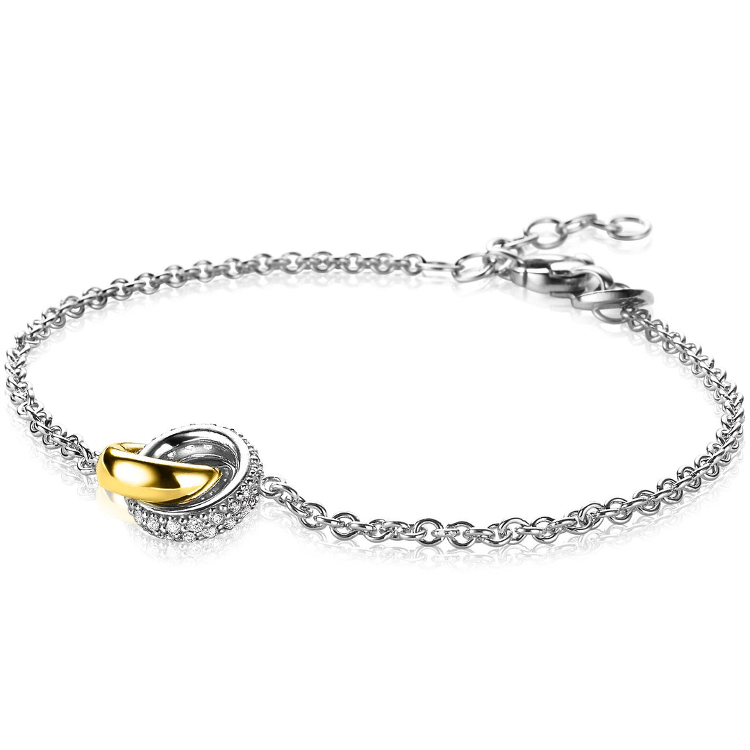 De Zinzi Armband Zilver Zia2102 van Zinzi heeft een delicate tweekleurige schakelketting en een in elkaar grijpende hanger met een gladde gouden ring en een zilveren ring versierd met fonkelende stenen.